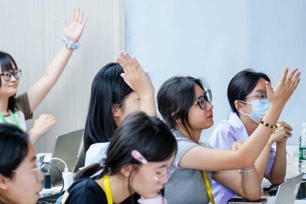 A group of people raising their hands
AI-generated content may be incorrect.